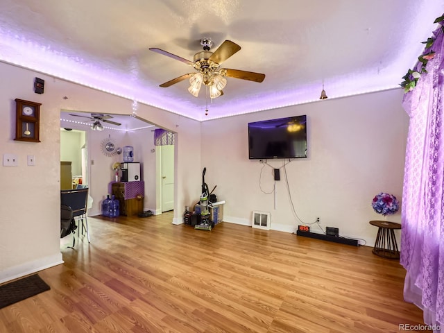 living room with ceiling fan and light hardwood / wood-style flooring