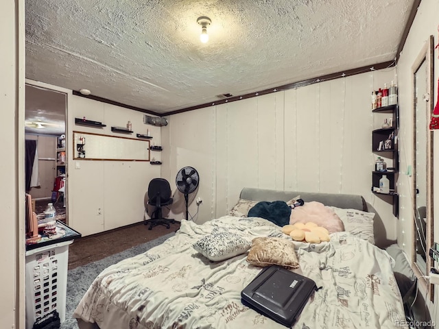 bedroom featuring dark carpet and a textured ceiling