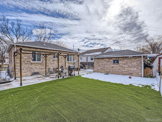 back of house featuring a shed, a yard, and a patio area