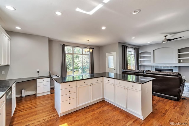 4630 Whitehall Ln, Highlands Ranch, CO 80126 - kitchen with recessed lighting, plenty of natural light, light wood-style floors, and white cabinetry