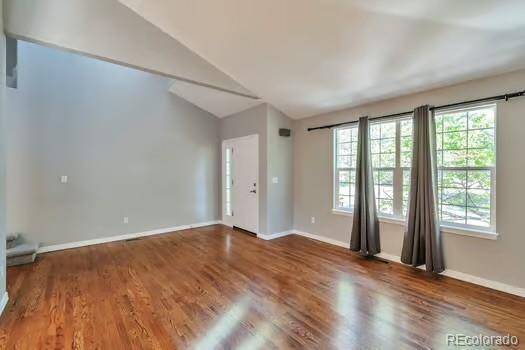 4630 Whitehall Ln, Highlands Ranch, CO 80126 - empty room with vaulted ceiling and wood finished floors