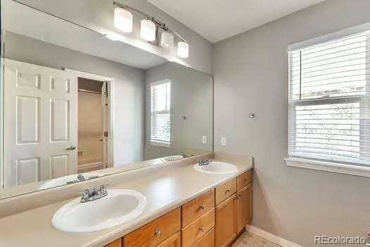 4630 Whitehall Ln, Highlands Ranch, CO 80126 - full bath featuring double vanity and baseboards