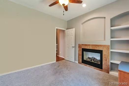 4630 Whitehall Ln, Highlands Ranch, CO 80126 - unfurnished living room with ceiling fan, carpet floors, and a tiled fireplace