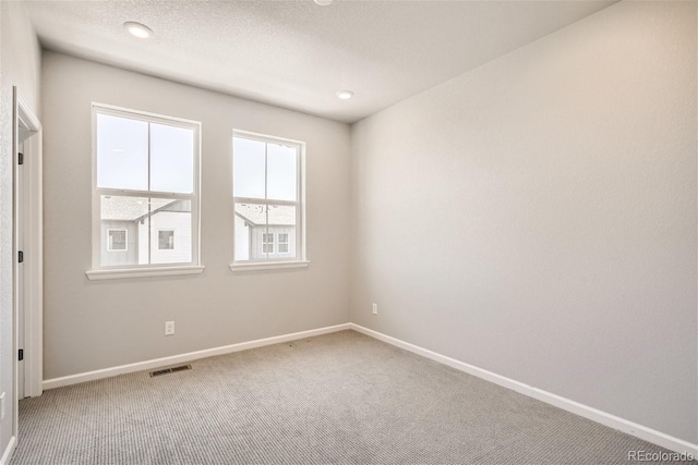 unfurnished room featuring carpet