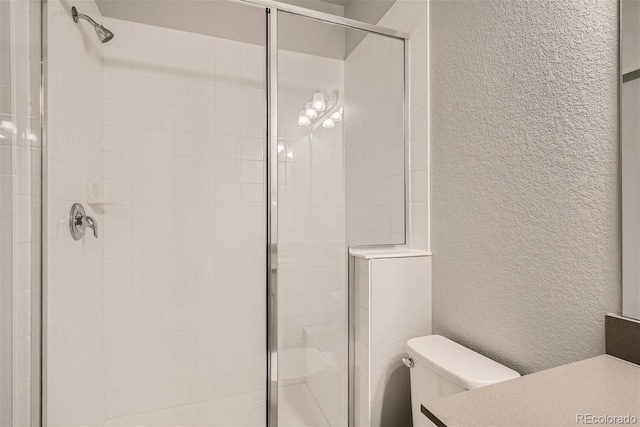 bathroom featuring an enclosed shower and toilet