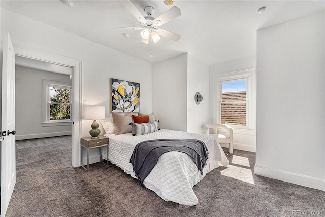 carpeted bedroom with baseboards, multiple windows, and ceiling fan