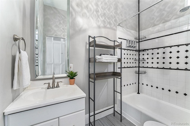 bathroom featuring vanity and  shower combination