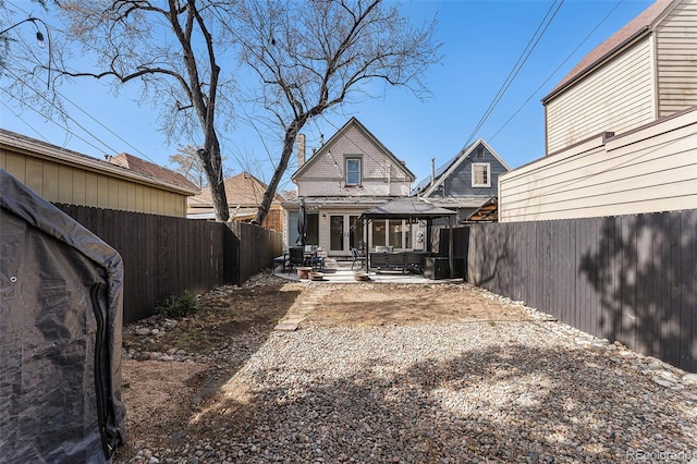 back of property with a patio and a fenced backyard