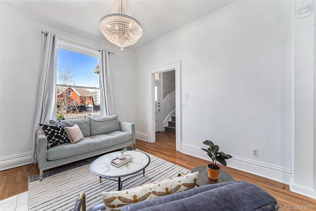 living room featuring wood finished floors, baseboards, an inviting chandelier, stairs, and crown molding