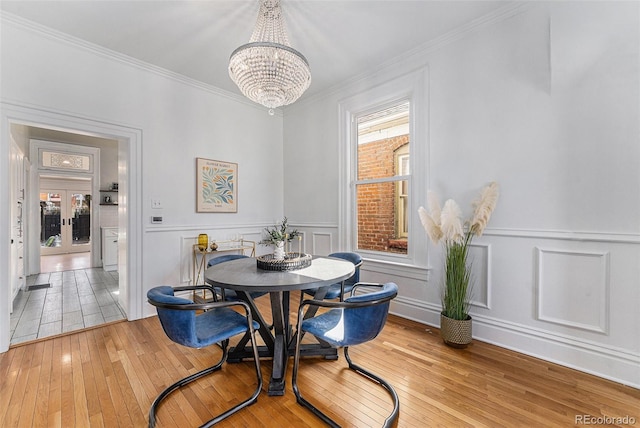 dining area featuring a healthy amount of sunlight, crown molding, and hardwood / wood-style flooring