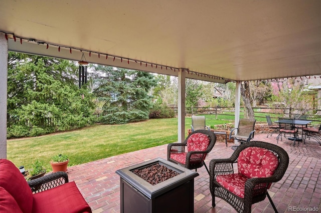 view of patio / terrace with an outdoor living space with a fire pit and fence