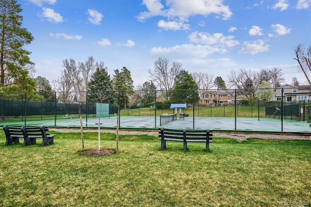 view of sport court with community basketball court, a yard, and fence