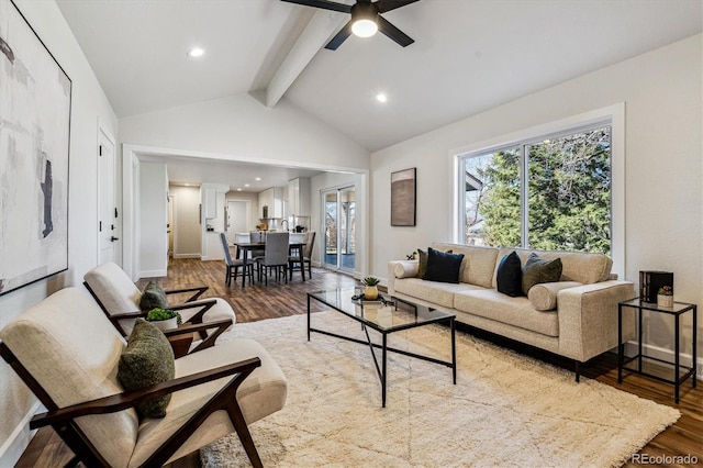 living area with baseboards, vaulted ceiling with beams, ceiling fan, and wood finished floors