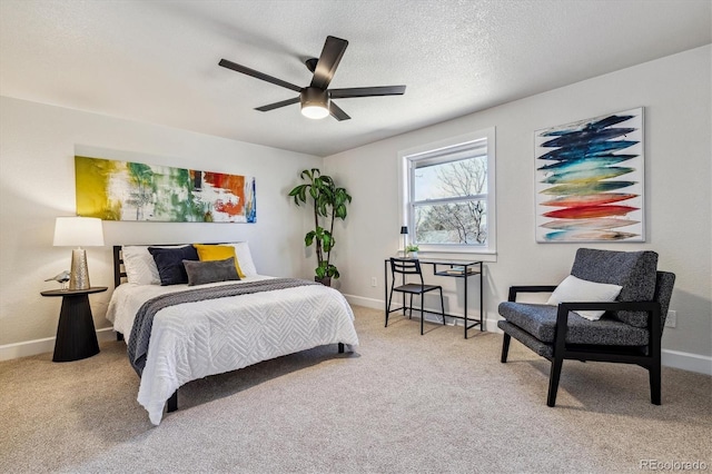 bedroom with ceiling fan, carpet flooring, baseboards, and a textured ceiling