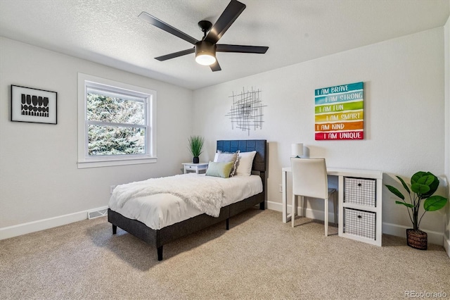 bedroom with visible vents, a textured ceiling, baseboards, and carpet floors