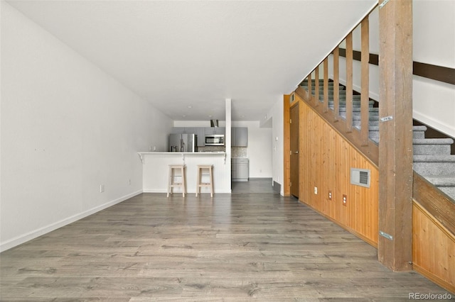 3550 S Harlan St Unit 363, Denver, CO 80235 - unfurnished living room with wood finished floors and stairway