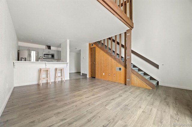 3550 S Harlan St Unit 363, Denver, CO 80235 - unfurnished living room featuring stairs and wood finished floors