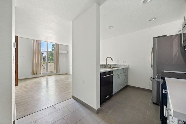 3550 S Harlan St Unit 363, Denver, CO 80235 - kitchen with dishwasher, light tile patterned floors, freestanding refrigerator, light countertops, and a textured ceiling