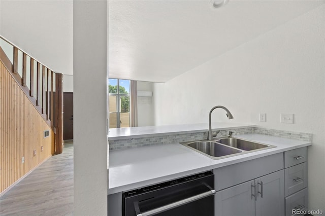 3550 S Harlan St Unit 363, Denver, CO 80235 - kitchen featuring dishwasher, gray cabinetry, light countertops, and light wood finished floors