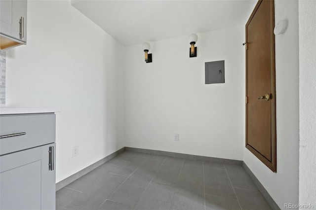 3550 S Harlan St Unit 363, Denver, CO 80235 - washroom with electric panel and dark tile patterned floors