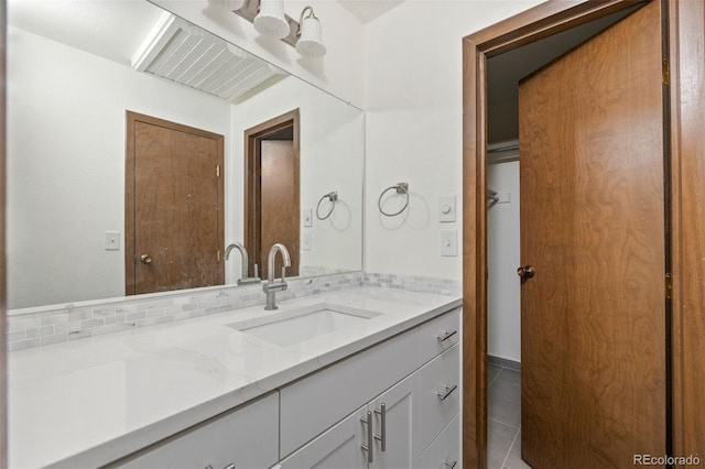 3550 S Harlan St Unit 363, Denver, CO 80235 - bathroom featuring vanity, tile patterned floors, and backsplash