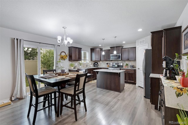 10869 Traders Pkwy, Fountain, CO 80817 - dining space featuring a chandelier, light wood-type flooring, and recessed lighting