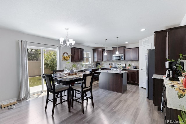 10869 Traders Pkwy, Fountain, CO 80817 - dining room with a chandelier, light wood-style flooring, and recessed lighting