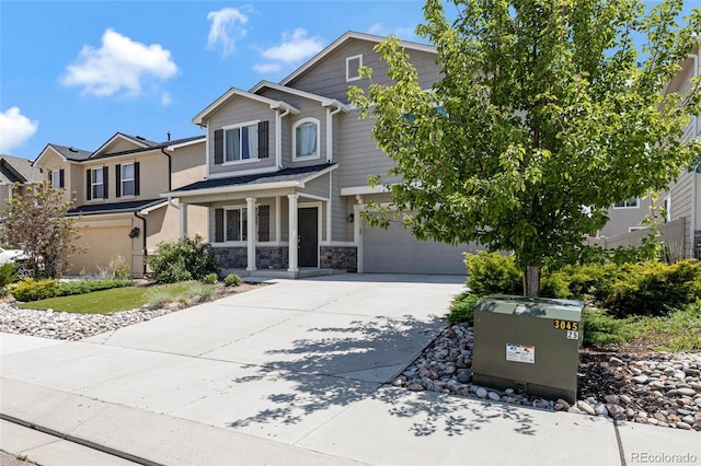 10869 Traders Pkwy, Fountain, CO 80817 - view of front of property with a garage, concrete driveway, stone siding, and a porch