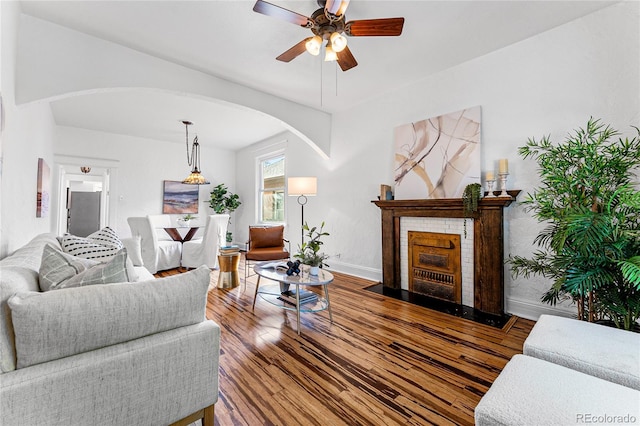 living room with ceiling fan and hardwood / wood-style floors