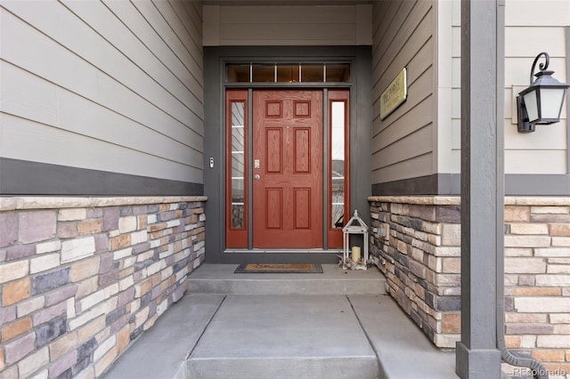 entrance to property featuring stone siding