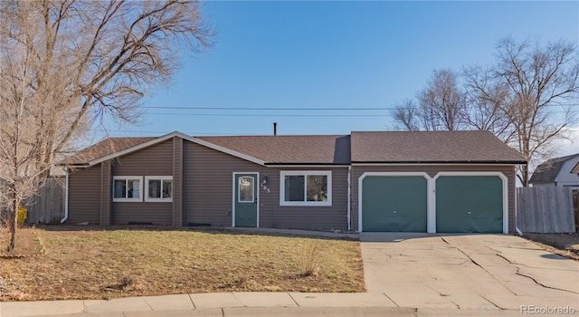 ranch-style home featuring driveway, a shingled roof, an attached garage, fence, and a front yard