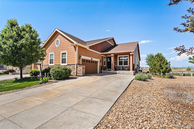 14805 Quince Way, Thornton, CO 80602 - view of front of house featuring a porch, an attached garage, stone siding, and concrete driveway