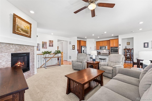 14805 Quince Way, Thornton, CO 80602 - living room featuring recessed lighting, a ceiling fan, a stone fireplace, and light carpet