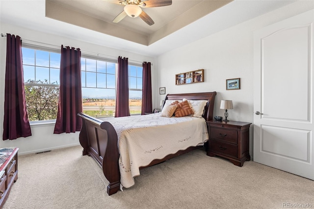 14805 Quince Way, Thornton, CO 80602 - bedroom with light colored carpet, a ceiling fan, and a tray ceiling