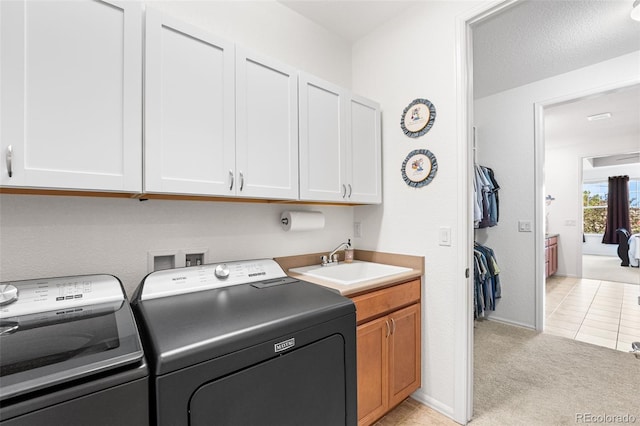 14805 Quince Way, Thornton, CO 80602 - laundry room with washing machine and clothes dryer, cabinet space, light colored carpet, and light tile patterned flooring