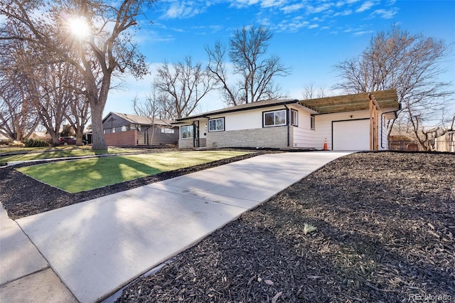 single story home with a garage and a front lawn