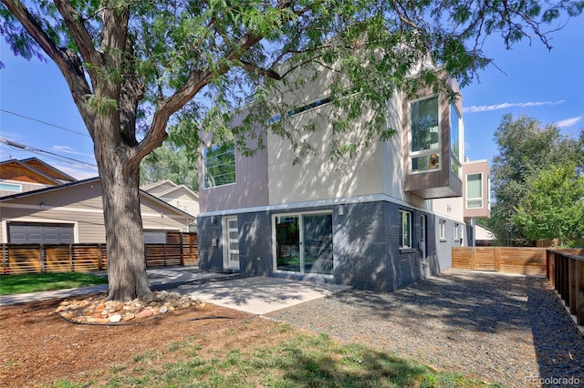 rear view of property featuring a patio area