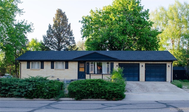 2308 Lelaray St, Colorado Springs, CO 80909 - ranch-style house with an attached garage, driveway, and brick siding