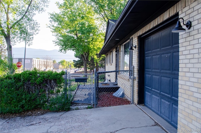 2308 Lelaray St, Colorado Springs, CO 80909 - view of side of property featuring brick siding and driveway