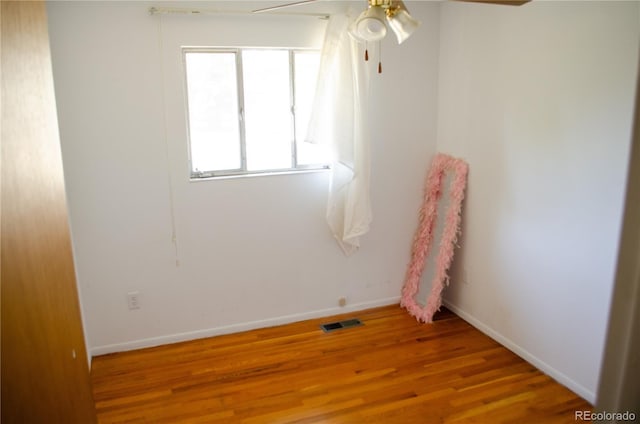 2308 Lelaray St, Colorado Springs, CO 80909 - spare room featuring wood finished floors, a ceiling fan, and baseboards