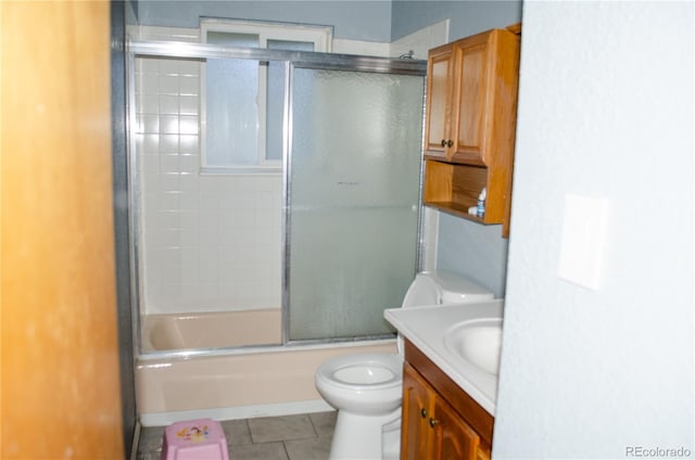 2308 Lelaray St, Colorado Springs, CO 80909 - bathroom featuring toilet, vanity, tile patterned floors, and enclosed tub / shower combo