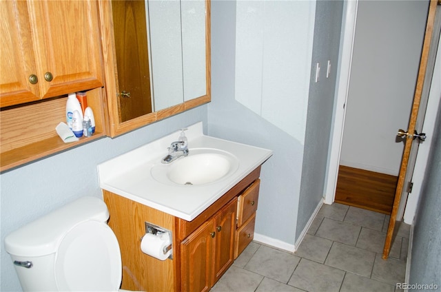 2308 Lelaray St, Colorado Springs, CO 80909 - half bathroom featuring vanity, toilet, and tile patterned floors