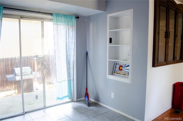 2308 Lelaray St, Colorado Springs, CO 80909 - tiled spare room with built in shelves and baseboards