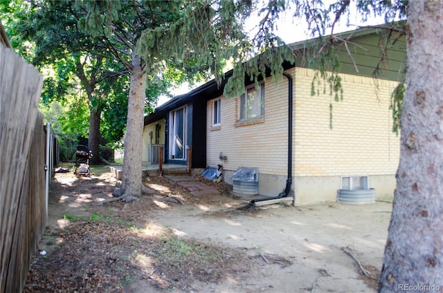 2308 Lelaray St, Colorado Springs, CO 80909 - rear view of property with brick siding and central air condition unit