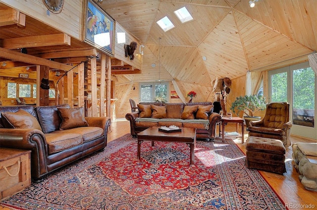 living room with hardwood / wood-style floors, high vaulted ceiling, wooden walls, and wooden ceiling