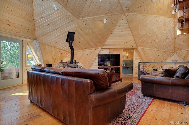 living room featuring wood ceiling, wood walls, high vaulted ceiling, and light hardwood / wood-style floors