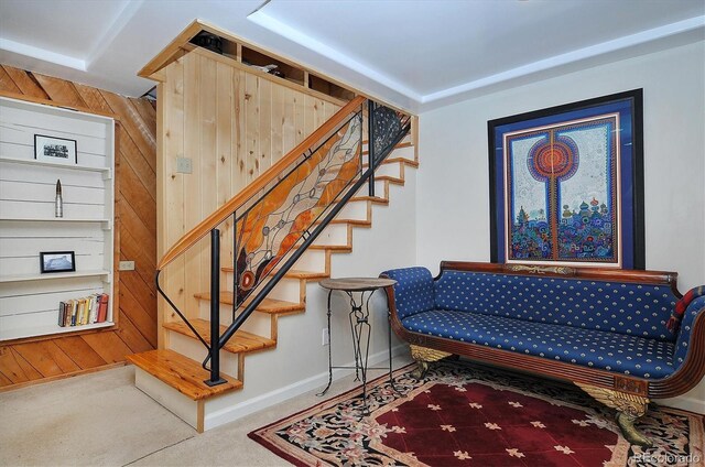 interior space featuring wood walls and carpet flooring