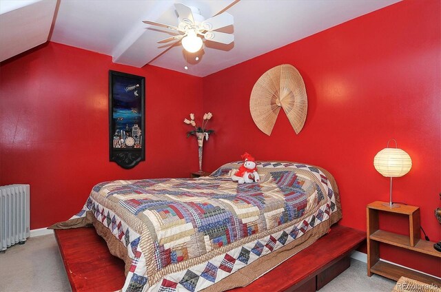 carpeted bedroom featuring radiator, vaulted ceiling, and ceiling fan