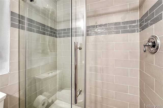 bathroom with a shower with shower door