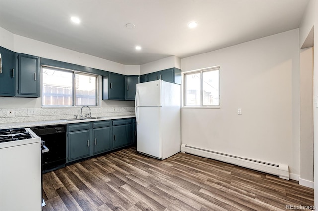 kitchen with sink, white appliances, baseboard heating, and dark wood-type flooring